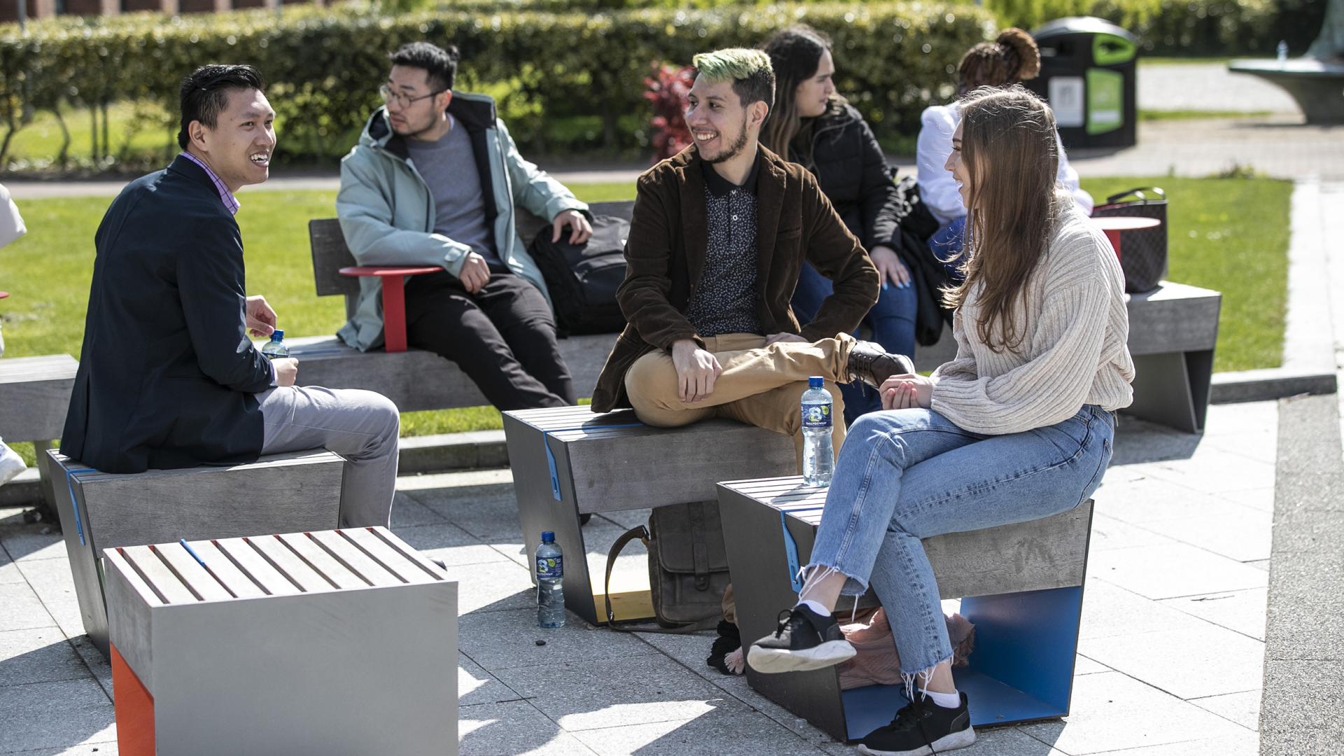 Shows group of international students on DCU campus