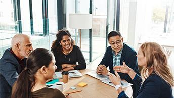 Colleagues talking around a table