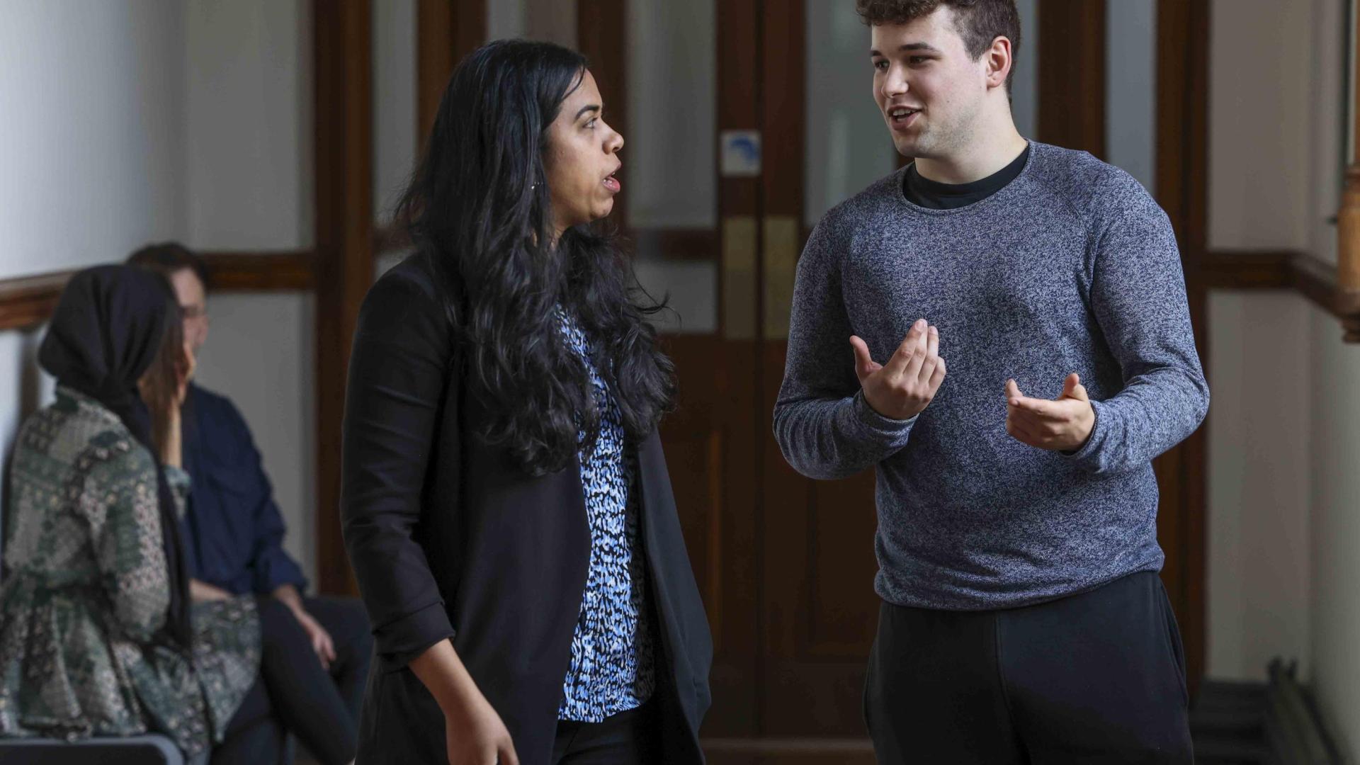 2 people having a conversations standing up