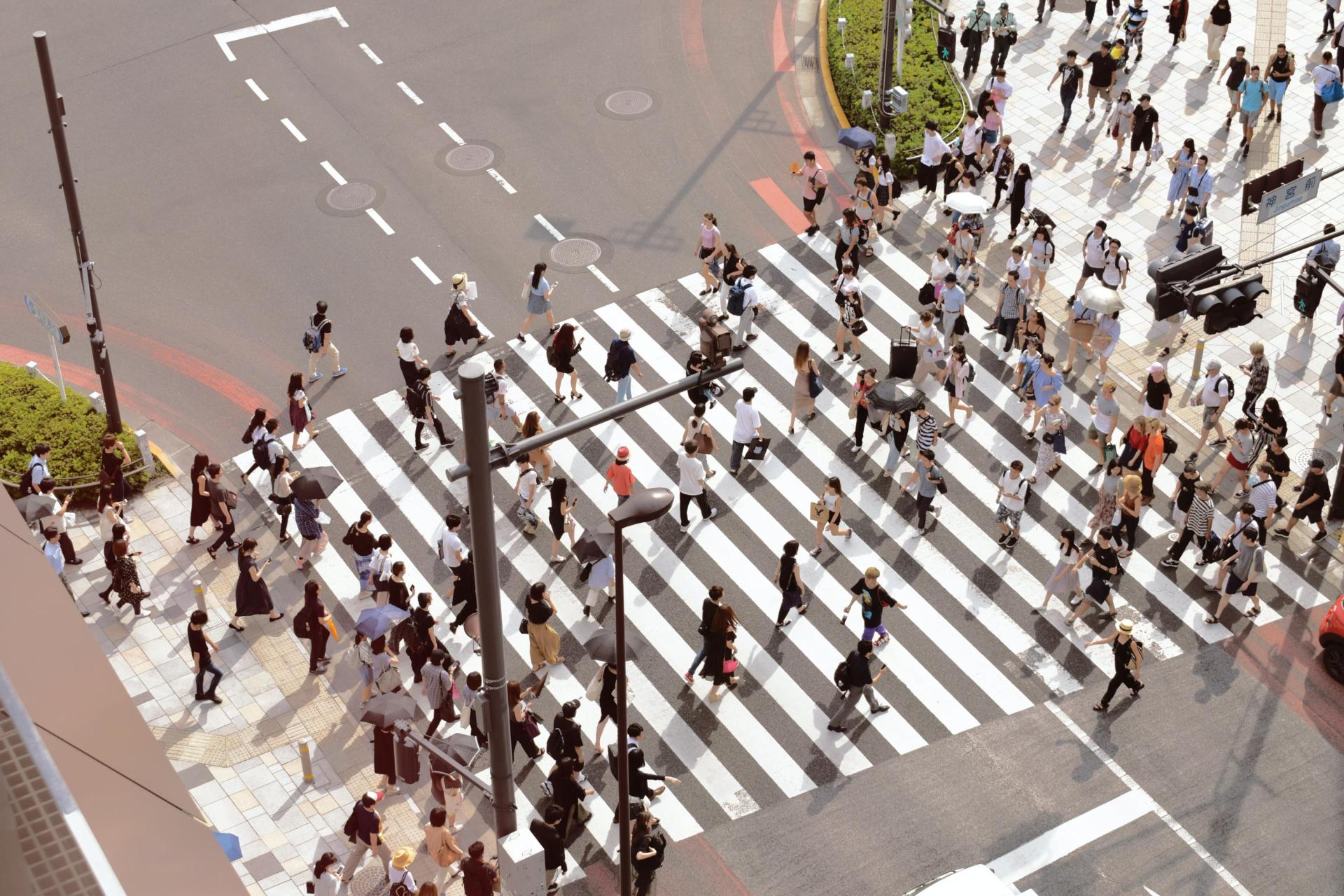 Crowd of people crossing at a pedestrian crossing