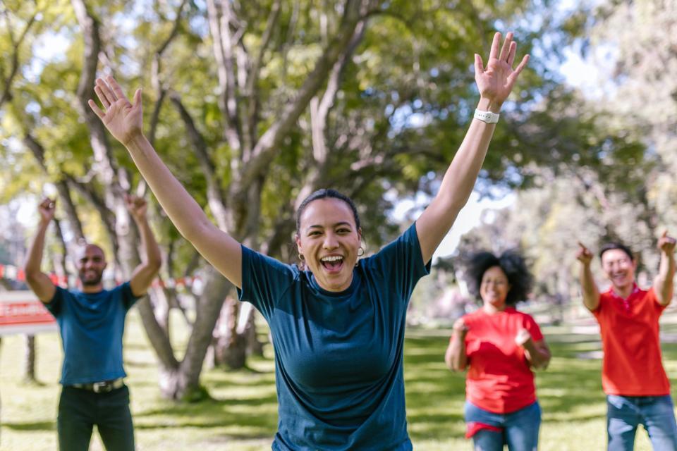 People cheering with arms in air