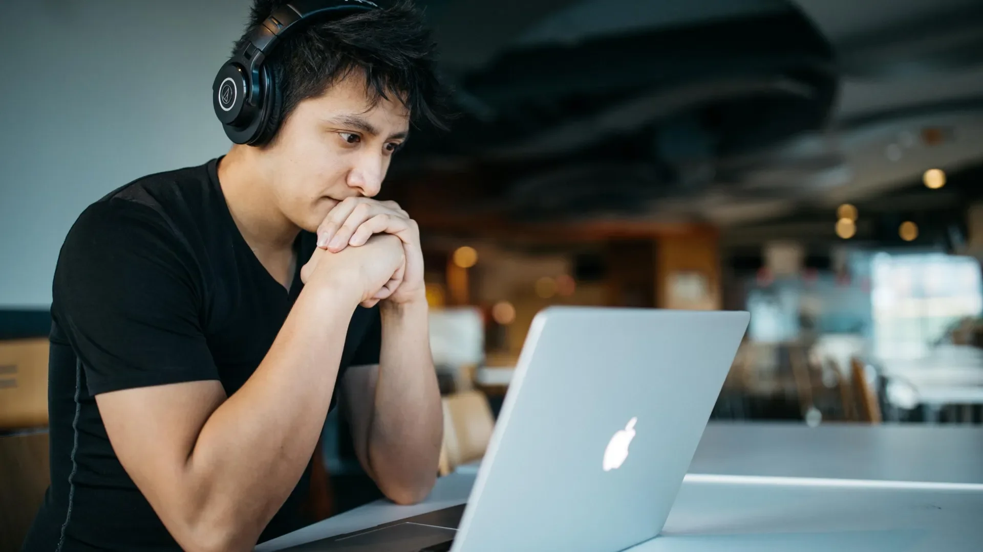 Man with headphones on looking at laptop