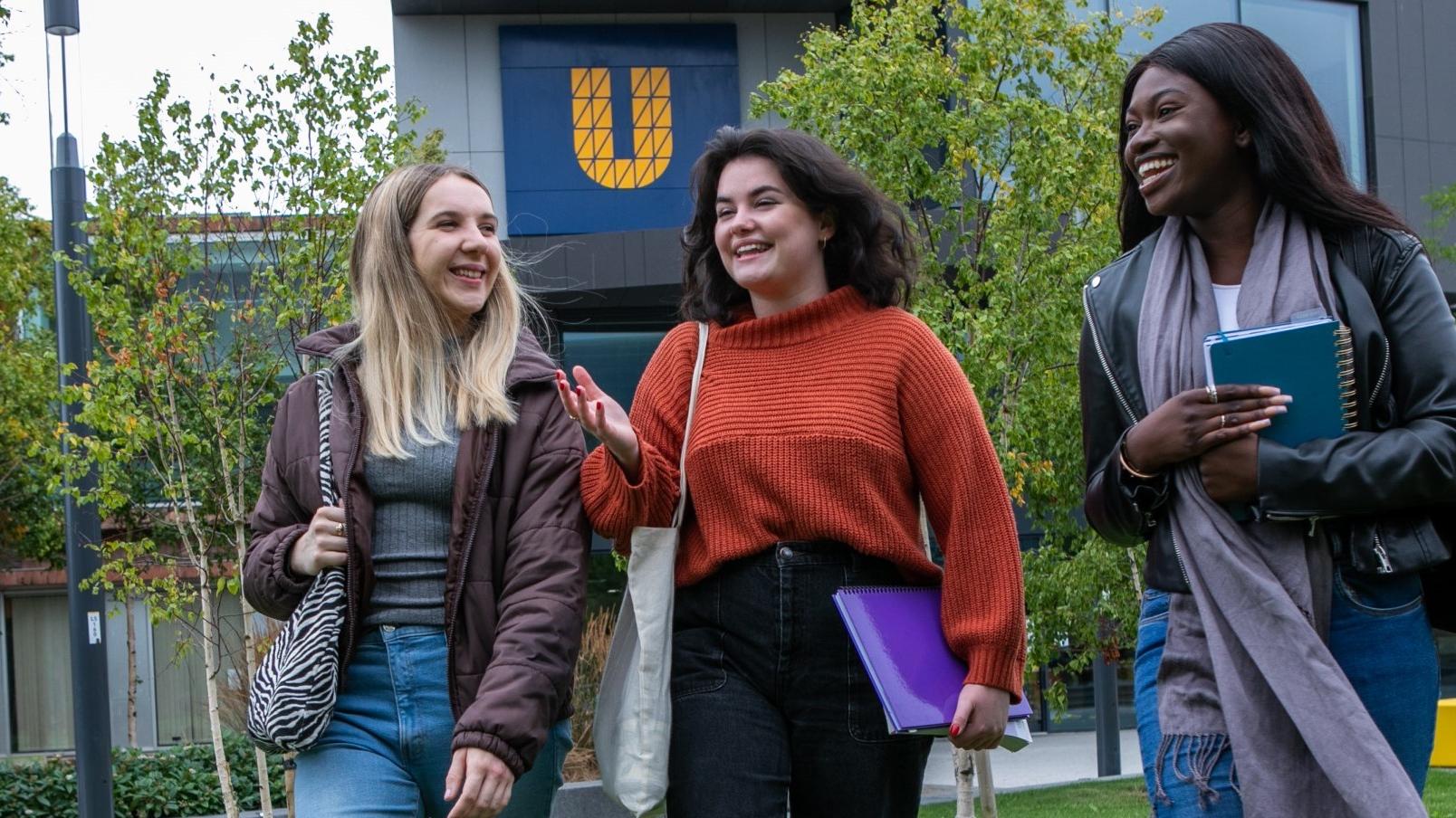 An image showing three students chatting on DCU's Glasnevin campus
