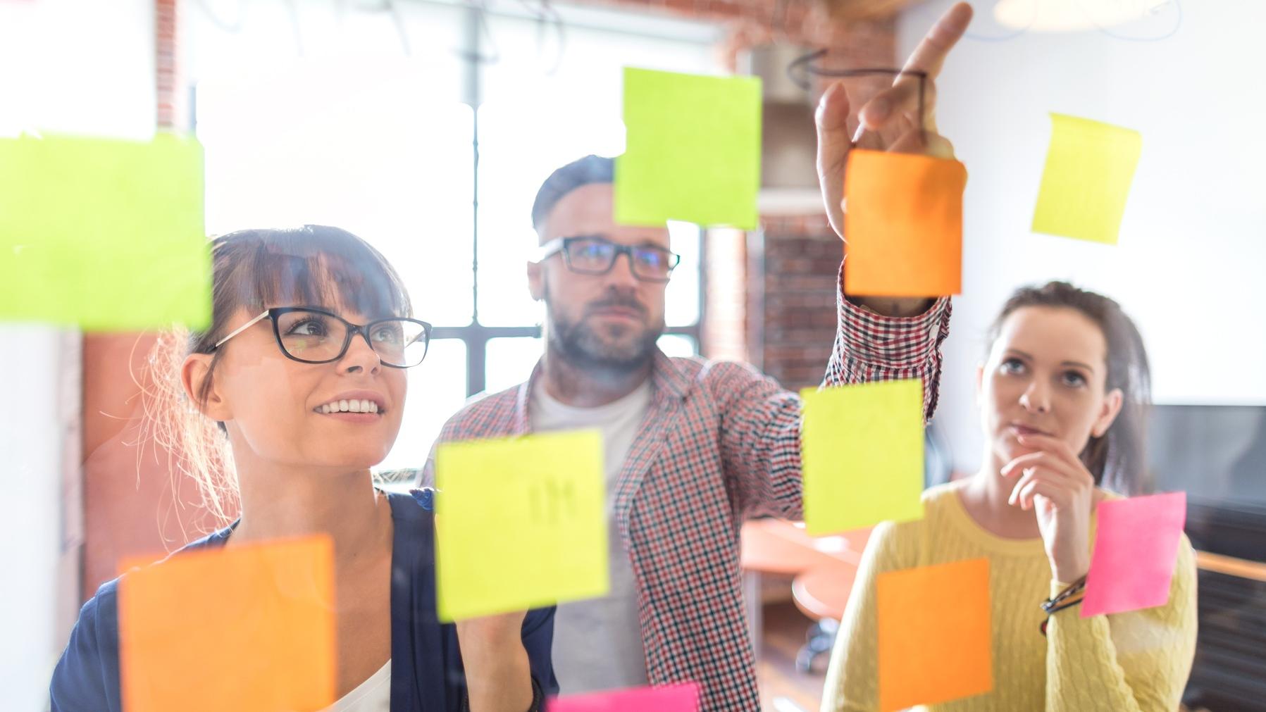 Researchers with post-its on a screen