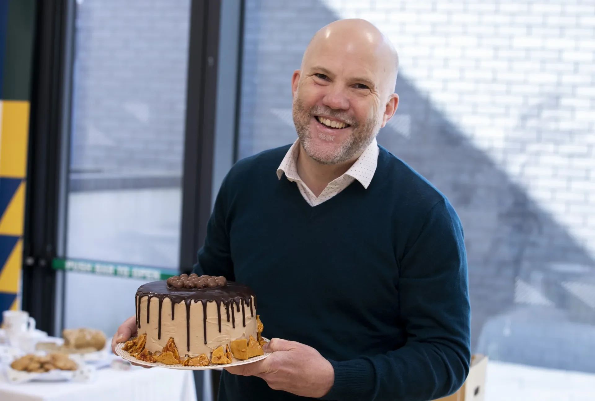 Shows Tom Swift with his Chocolate Drip Cake during the DCU Bake Off for Barretstown
