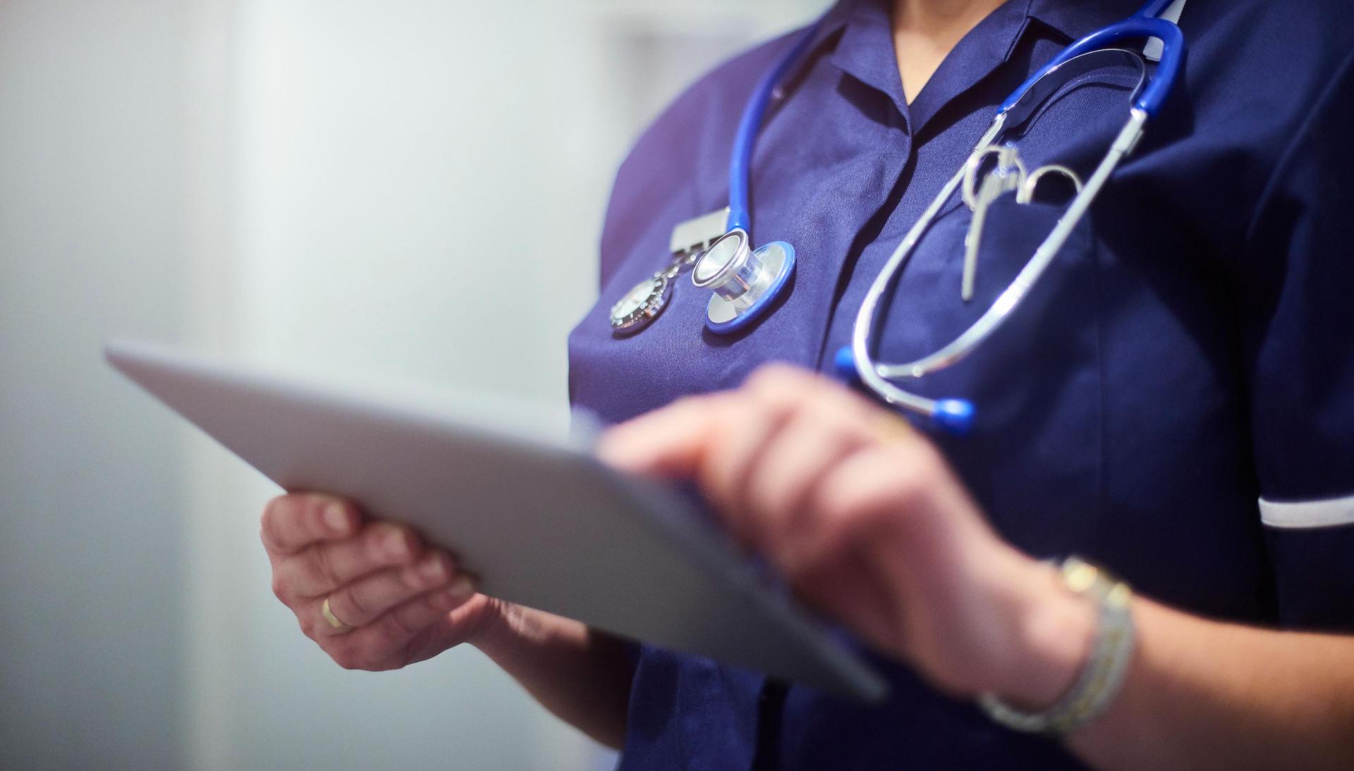 Image of Nurse looking at clipboard
