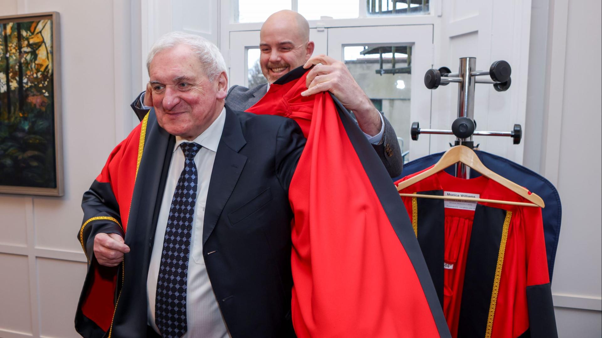Bertie Ahern donning his robe ahead of his honorary conferring