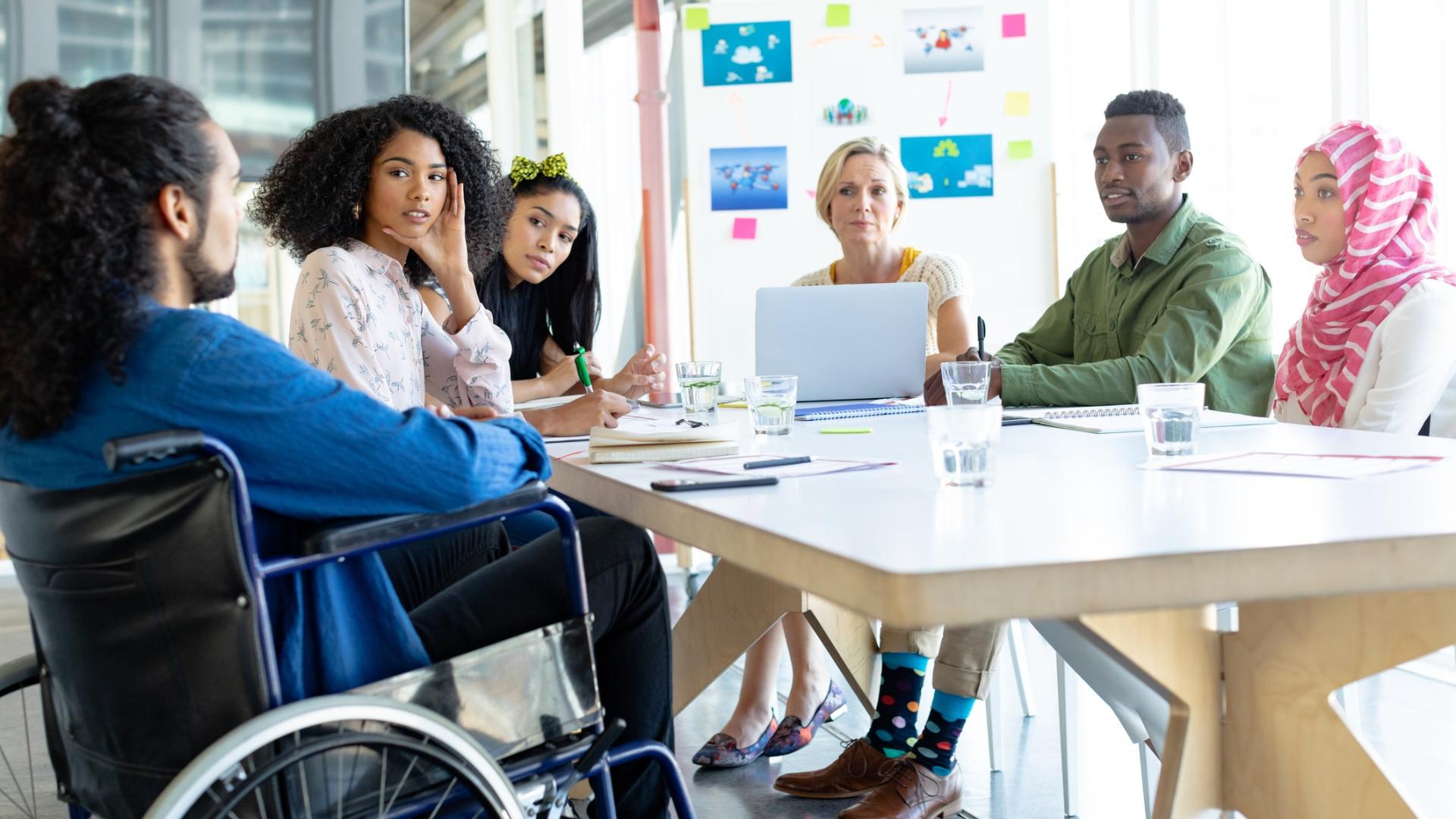 A group of colleagues sitting around a conference table having a discussion.