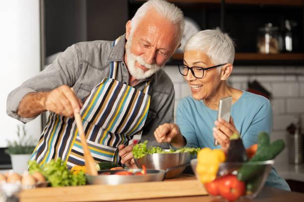 two older people are cooking together