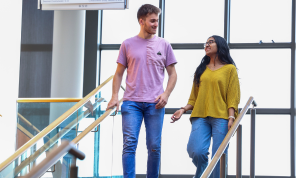 2 students walking down the stairs in O' Reilly library