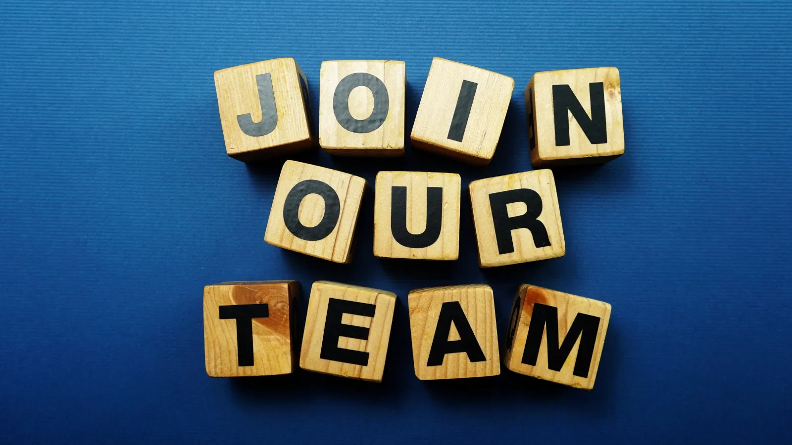 navy background with building blocks spelling the words: join our team