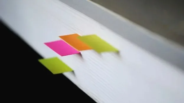 The edge of a book with page markers 