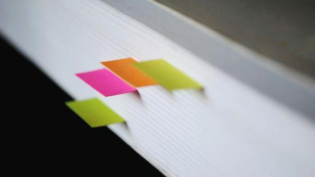 The edge of a book with page markers 