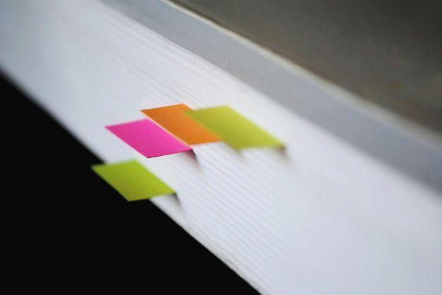 The edge of a book with page markers 