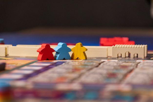 three figures set out on a boardgame 